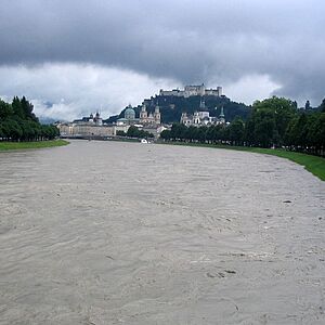 Blick auf die Festung Hohensalzburg vom Müllnersteg. Im Vorderung ist die Salzach mit Hochwasser.