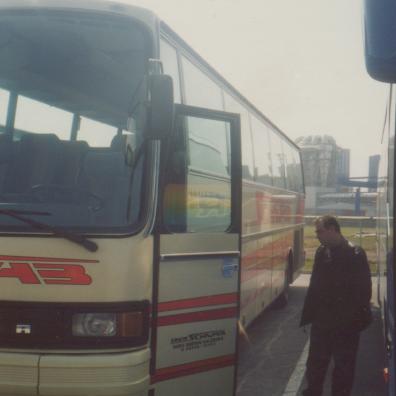 Mann neben einem Reisebus